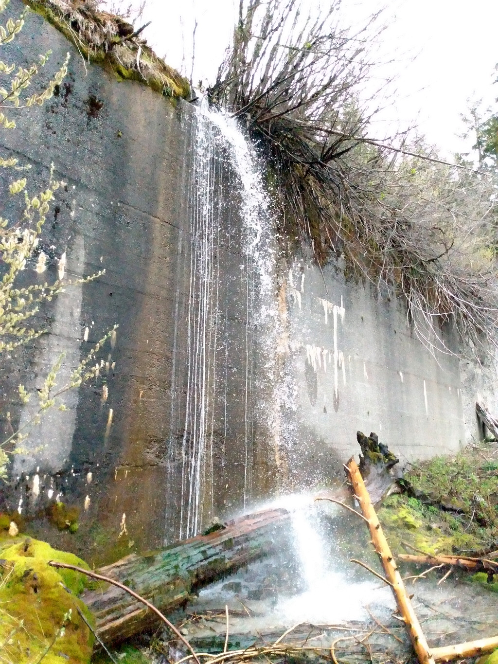 time has blocked all the wall drains, resulting on the water now going over the wall slowly weakening it.